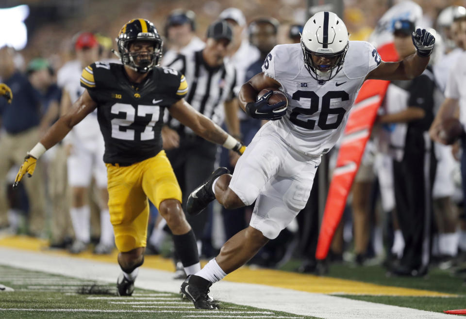 Saquon Barkley, right, is unable to stay in bounds as Iowa defensive back Amani Hooker watches during the first. (AP)