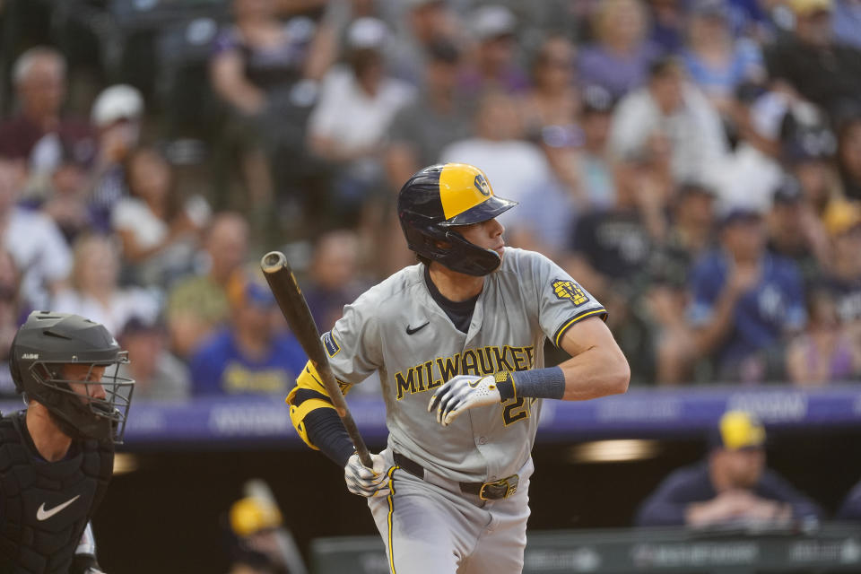 Milwaukee Brewers' Christian Yelich singles against Colorado Rockies starting pitcher Ryan Feltner in the fifth inning of a baseball game Tuesday, July 2, 2024, in Denver. (AP Photo/David Zalubowski)