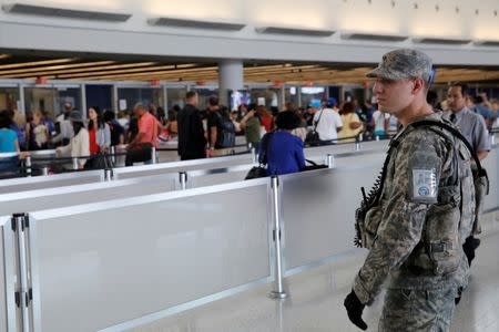 A U.S. Army Specialist monitors the security line at John F. Kennedy international Airport in the Queens borough of New York, U.S., June 29, 2016. REUTERS/Andrew Kelly