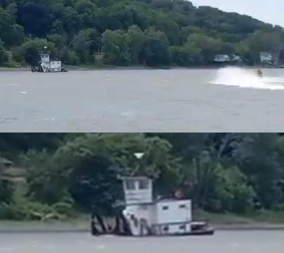 Josh Bradshaw on his jet-ski as he zips near a sinking tugboat operated by Dick Hamm on the Illinois River on Saturday, June 25, 2022.