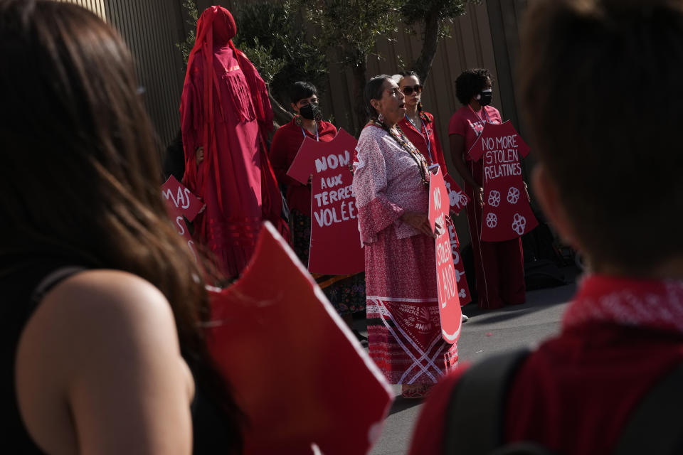 Demonstrators hold signs as part of a protest demanding no more stolen relatives and stolen land with the group Indigenous Women Action at the COP27 U.N. Climate Summit, Tuesday, Nov. 15, 2022, in Sharm el-Sheikh, Egypt. (AP Photo/Peter Dejong)