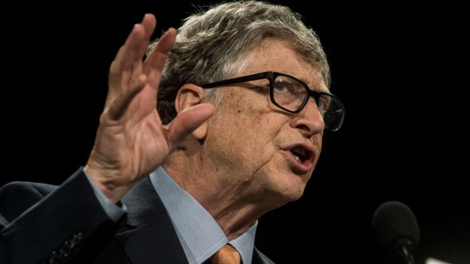 Bill Gates gesticulates while speaking. 