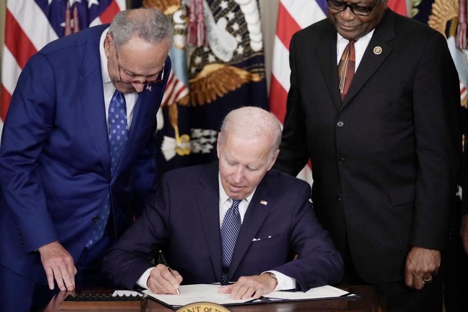 U.S. President Joe Biden (C) signs The Inflation Reduction Act with Senate Majority Leader Charles Schumer (D-NY) (L) and House Majority Whip James Clyburn (D-SC) in the State Dining Room of the White House August 16, 2022 in Washington, DC. The $739 billion bill focuses on climate change, lower health care costs and creating clean energy jobs by enacting a 15% corporate minimum tax, a 1-percent fee on stock buybacks and enhancing IRS enforcement.