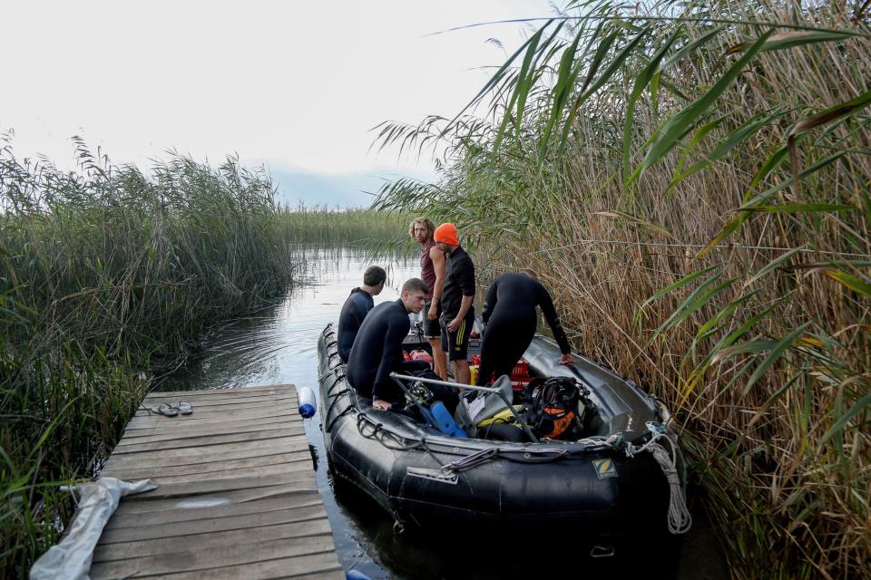 Divers prepare to leave to continue their research in Lake Ohrid, near the shoreline of the Lin Village, southeastern Albania on July 27, 2023. A mixed team of Albanian and Swiss archaelogists from the Univesity of Bern have confirmed that the the Palafitte settlement of Lin dates back to 5800 - 6,000 years BC, making it the oldest lakeside village in Europe discovered to date. The village is believed to have consisted of houses built on stilts above the lake's surface or in areas regularly flooded by rising waters.