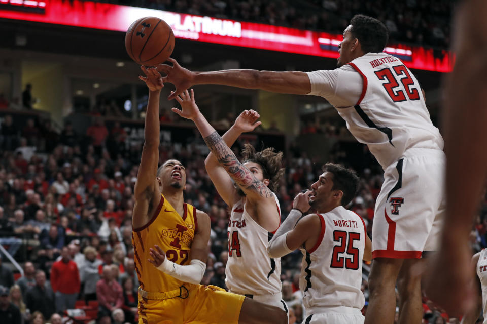 Texas Tech's Avery Benson (24) and TJ Holyfield (22) block a shot by Iowa State's Tyrese Haliburton (22) during the second half of an NCAA college basketball game Saturday, Jan. 18, 2020, in Lubbock, Texas. (AP Photo/Brad Tollefson)