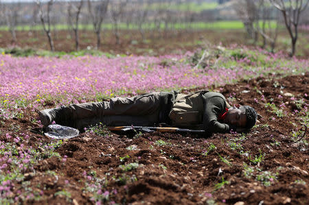 A Turkish-backed Free Syrian Army fighter is seen resting in eastern Afrin, Syria March 9, 2018. REUTERS/ Khalil Ashawi