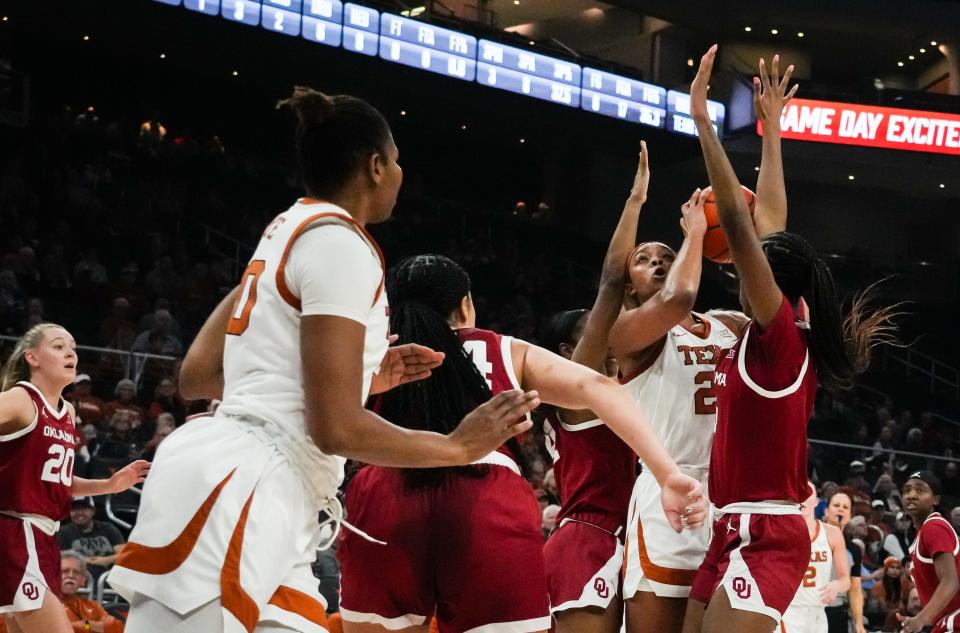 Texas Longhorns forward Aaliyah Moore (23) battles Oklahoma Sooners defense to get the ball up during the first half of the Longhorns' game against the Oklahoma Sooners at the Moody Center in Austin, Texas, Jan 24, 2024.