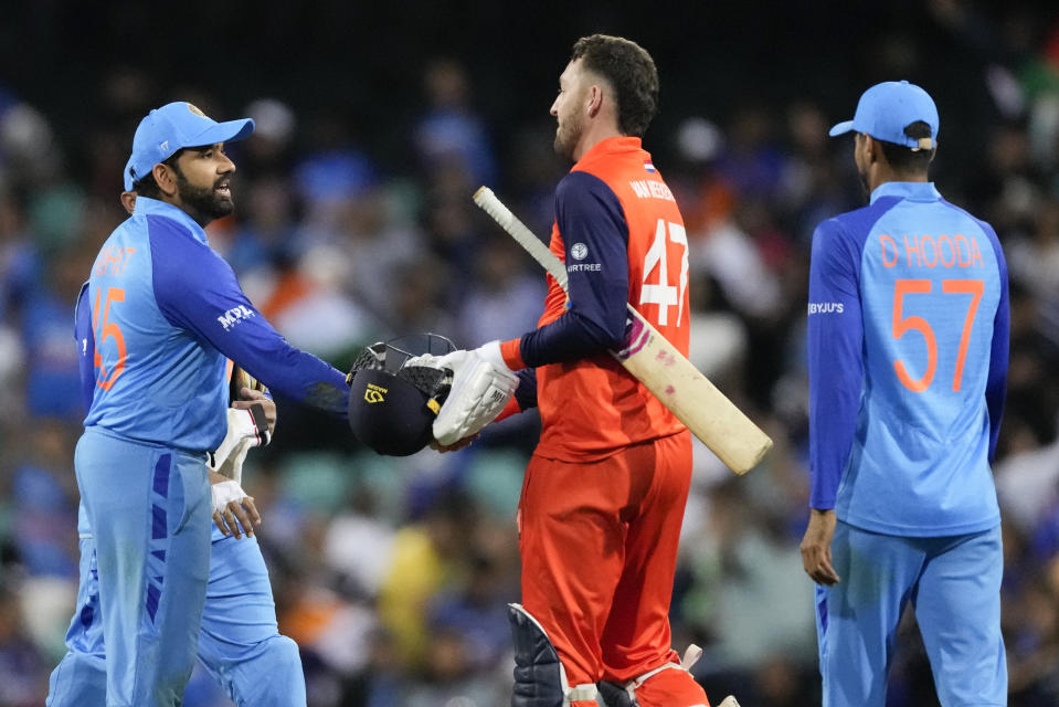 India's Rohit Sharma, left, is congratulated by Netherlands' Paul van Meekeren following the T20 World Cup cricket match between India and the Netherlands in Sydney, Australia, Thursday, Oct. 27, 2022. India defeated the Netherlands by 56 runs. (AP Photo/Rick Rycroft)