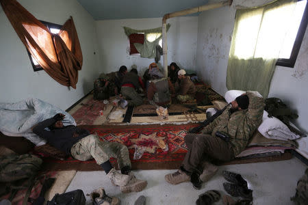 Rebel fighters rest inside a safehouse on the outskirts of the northern Syrian town of al-Bab, Syria February 8, 2017. REUTERS/Khalil Ashawi