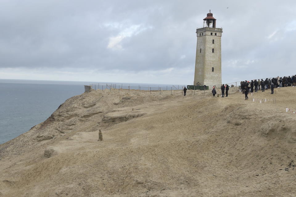 People look on as the lighthouse in Rubjerg Knude is being moved away from the coastline (Picture: AFP/Getty)