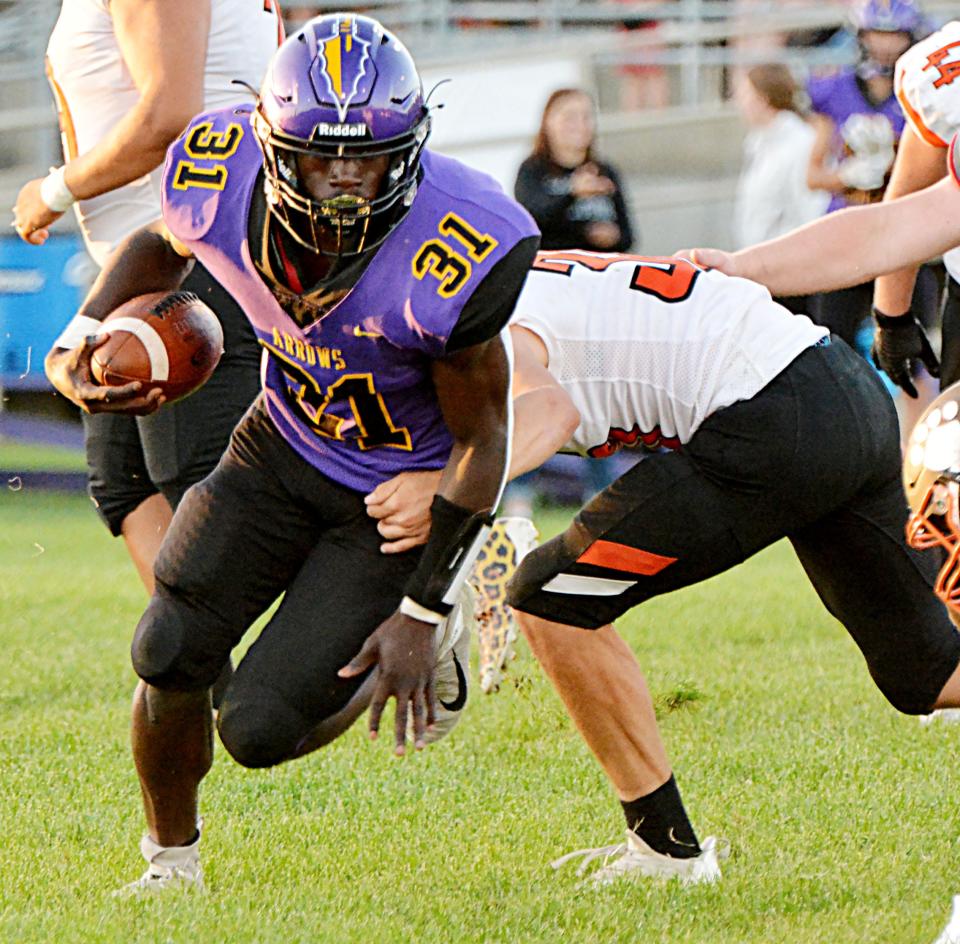 Watertown's Juven Hudson springs away from a Huron defender during their Eastern South Dakota Conference football game Friday night at Watertown Stadium. The Arrows won 34-19.