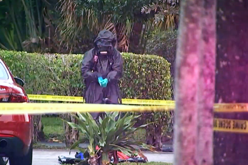 An investigator in a hazard suit stands outside the Spring Break home of West Point cadets who overdosed on cocaine laced with fentanyl, according to reports, in Ft Lauderdale, Fla., on Friday. (WTVJ)