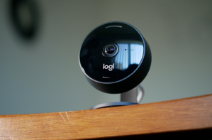 black logitech indoor camera sitting on shelf