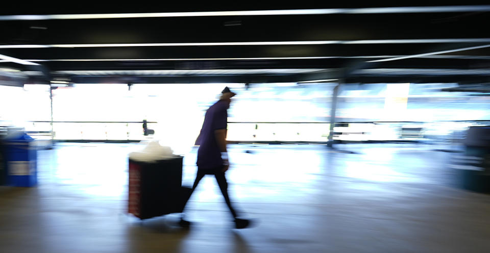 A concession worker pulls a tub of ice to a stand on the main concourse of Coors Field before the Colorado Rockies host the Pittsburgh Pirates in a baseball game Sunday, June 16, 2024, in Denver. (AP Photo/David Zalubowski)