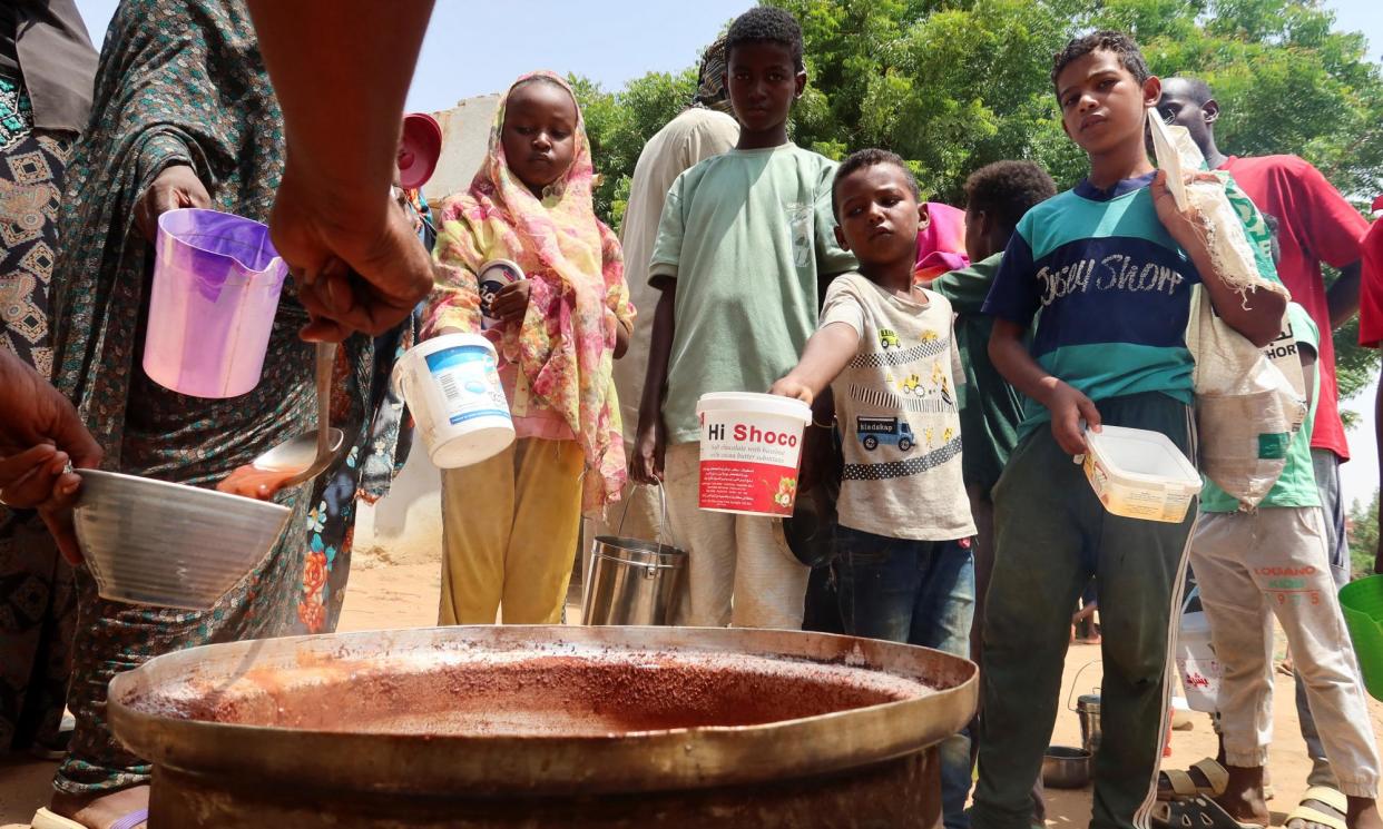 <span>Volunteers distribute food in Omdurman, Sudan, September 2023, where conflict has displaced more than 10 million people. </span><span>Photograph: El Tayeb Siddig/Reuters</span>