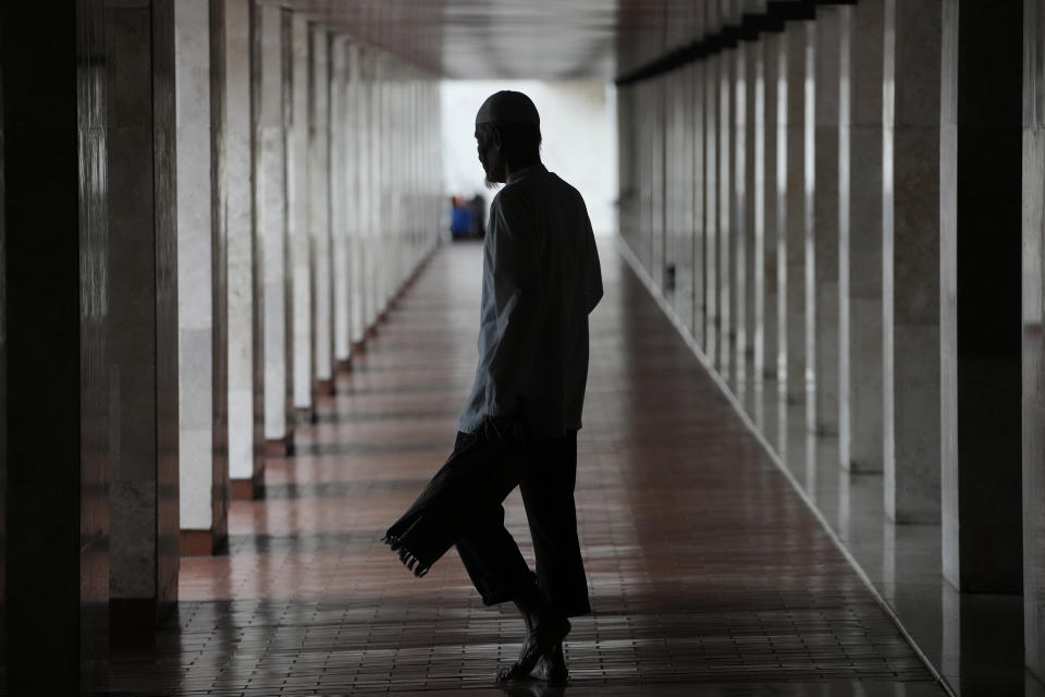 Muslim walks through the hallway of the Istiqlal Mosque during the first day of Ramadan in Jakarta, Indonesia, Tuesday, March 12, 2024. (AP Photo/Achmad Ibrahim)