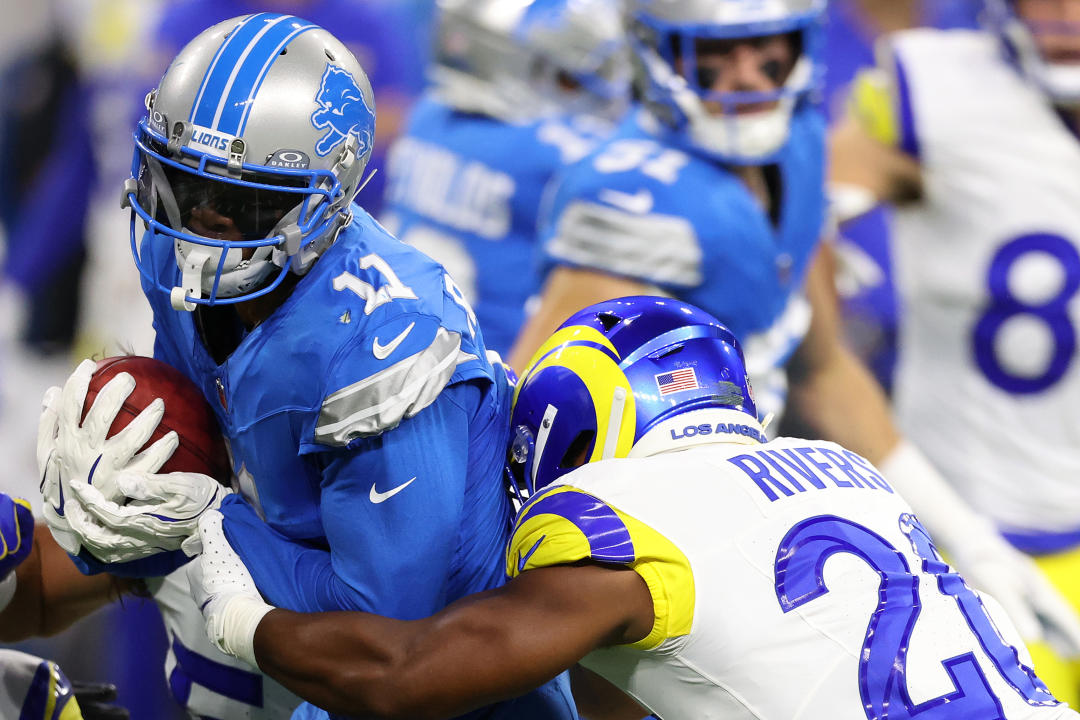 DETROIT, MICHIGAN – SEPTEMBER 8: Kalif Raymond #11 of the Detroit Lions is tackled by Kamren Kinchens #26 of the Los Angeles Rams during a punt return in the first quarter at Ford Field on September 8, 2024 in Detroit, Michigan. (Photo by Gregory Shamus/Getty Images)