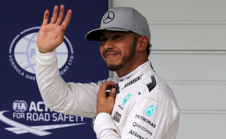 Formula One - F1 - Brazilian Grand Prix - Circuit of Interlagos, Sao Paulo, Brazil - 12/11/2016 - Mercedes' driver Lewis Hamilton of Britain celebrates pole position after qualifying session. REUTERS/Paulo Whitaker