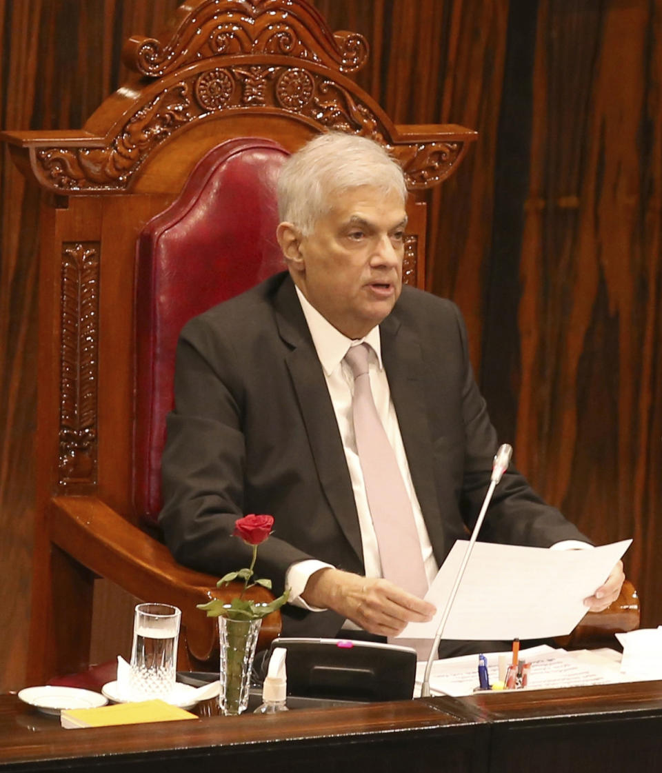 In this handout photo provided by then Sri Lankan President's Office, President Ranil Wickremesinghe delivers his policy speech to lawmakers during the opening of the new parliamentary session in Colombo, Sri Lanka, Wednesday, Aug. 3, 2022. (Sri Lankan President's Office via AP)