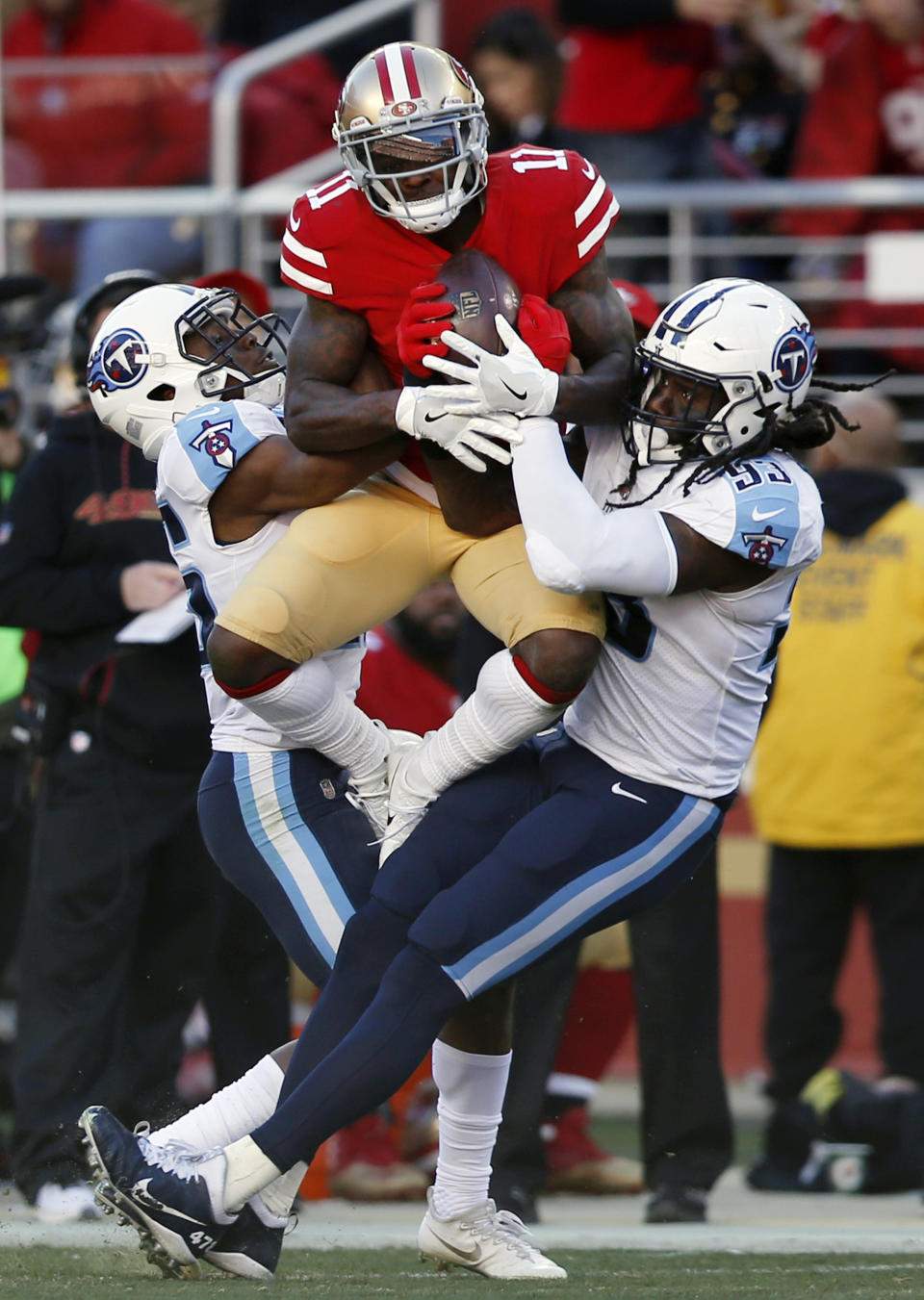 <p>San Francisco 49ers wide receiver Marquise Goodwin, center, makes a catch between Tennessee Titans linebacker Erik Walden, left, and cornerback Adoree’ Jackson, right during the first half of an NFL football game Sunday, Dec. 17, 2017, in Santa Clara, Calif. (AP Photo/D. Ross Cameron) </p>