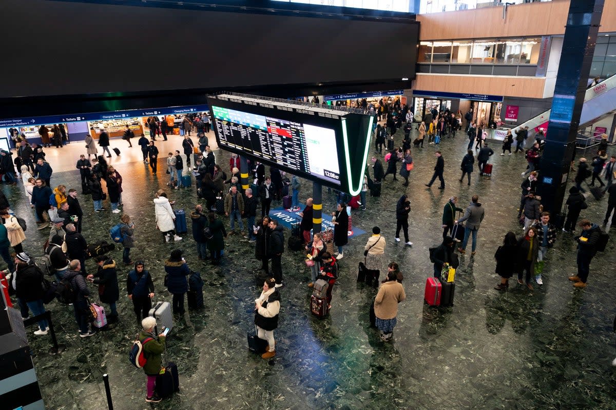Passengers at Euston station following train delays as Storm Isha has brought severe disruption to rail services (PA)