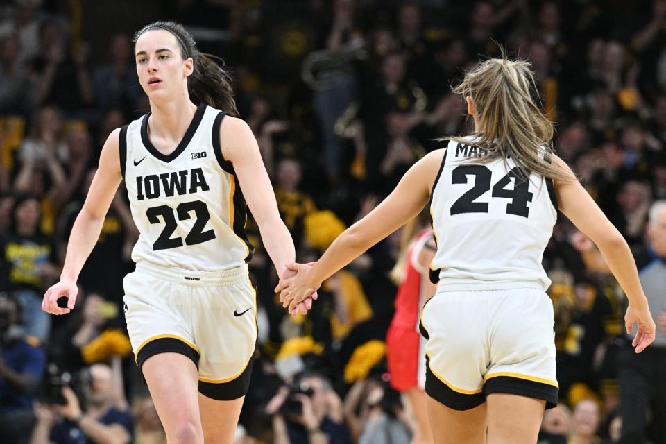 Iowa's Caitlin Clark (22) and Gabbie Marshall react during Sunday's game against Ohio State.