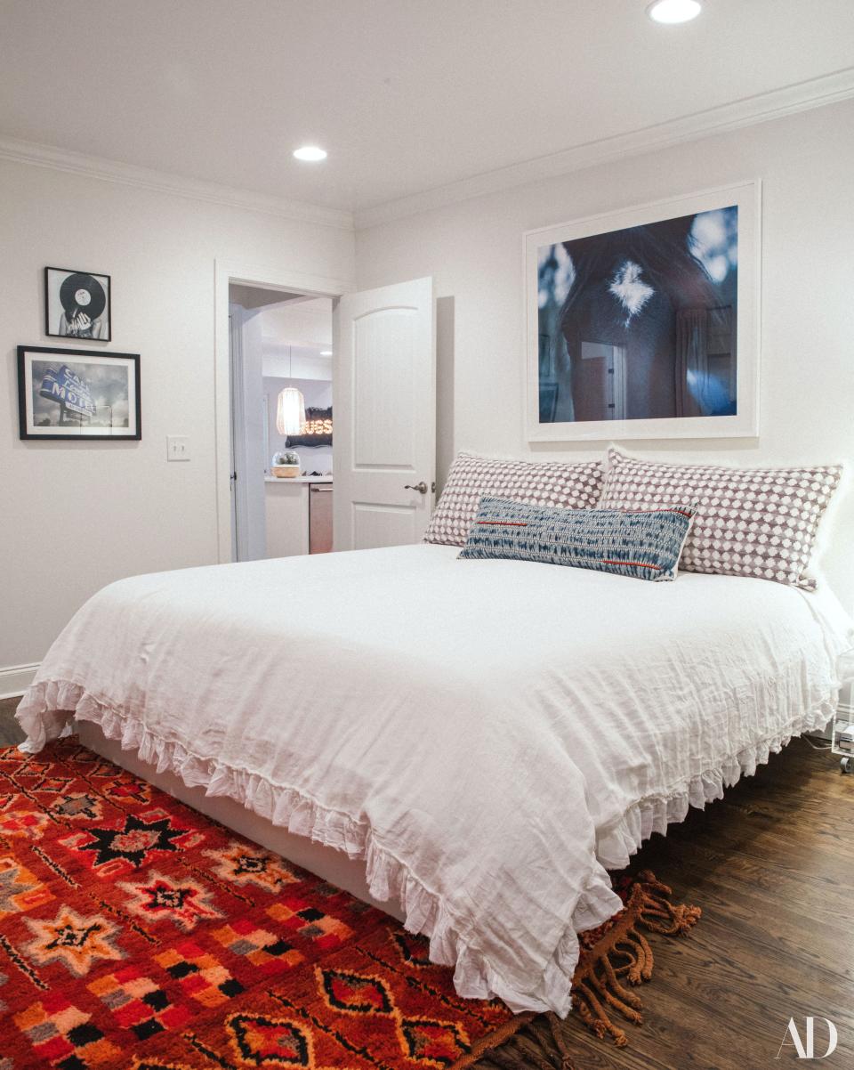 "This was all me," Cyrus says. "I did ask Brandi for advice." Another mostly white guest bedroom is offset with a colorful vintage rug.