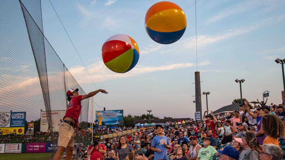 Fans enjoy a beach ball toss during a Jersey Shore BlueClaws game at ShoreTown Ballpark in Lakewood.