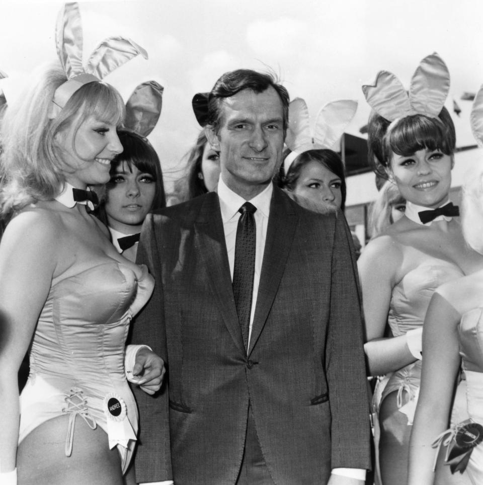 Playboy editor and tycoon Hugh Hefner is greeted by a group of Bunnies from his Playboy Clubs&nbsp;as he arrives in London in 1966. (Photo: Dove via Getty Images)