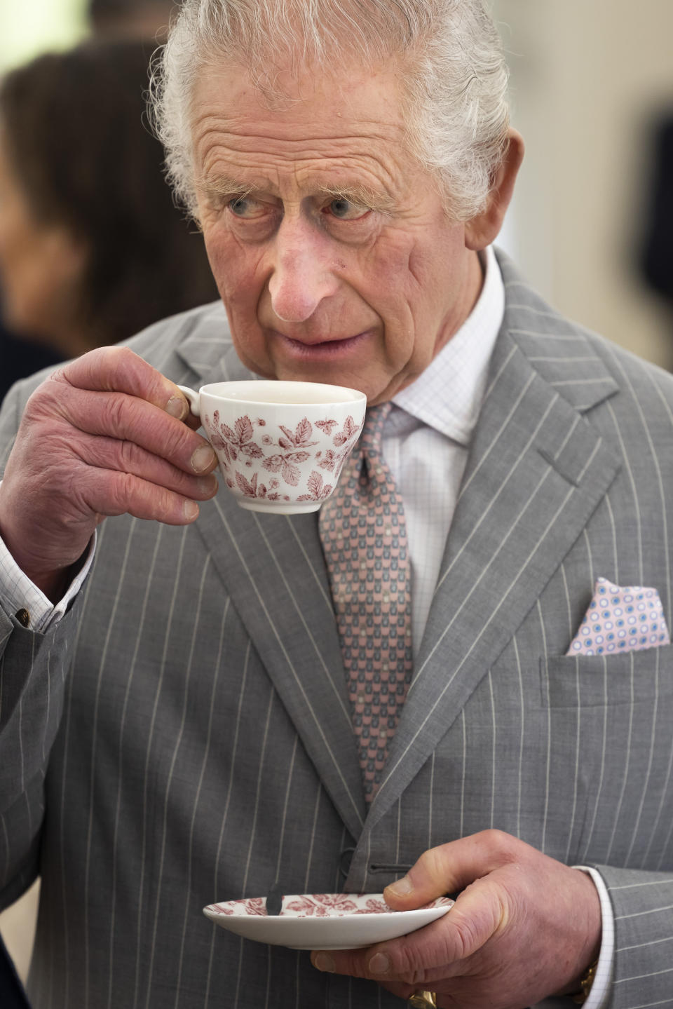 FILE - Britain's King Charles III sips tea, during a visit to Talbot Yard, in Yorkersgate, Malton, North Yorkshire, England, Wednesday April 5, 2023. (James Glossop/Pool Photo via AP, File)