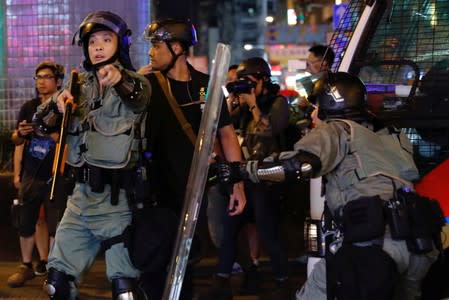 Riot police stand guard after an anti-extradition bill march at Mongkok