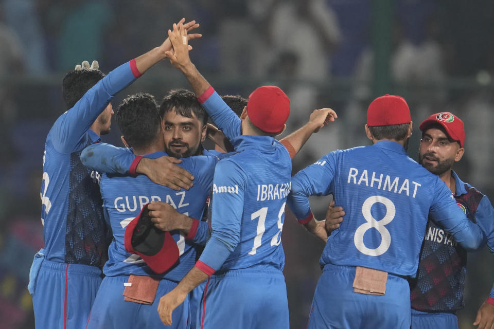 Afghanistan's team members celebrate their victory over England by 69 runs in the ICC Men's Cricket World Cup match between Afghanistan and England in New Delhi, India, Sunday, Oct. 15, 2023. (AP Photo/Manish Swarup)