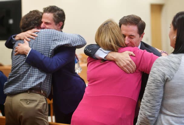 PHOTO: Plaintiff William Sherlach hugs attorney Josh Koskoff while plaintiff Nicole Hockley hugs attorney Chris Mattei following the jury verdict in Waterbury, Conn., Oct. 12, 2022. (Hearst Connecticut Media/Pool via Reuters)