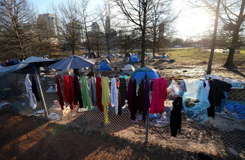 Personal items are hung on a fence at the tent encampment near Graham Street in Charlotte, NC on Friday, February 19, 2021. Residents of tent encampment are being required to vacate the area after health risks from rodent infestation was found in the area.