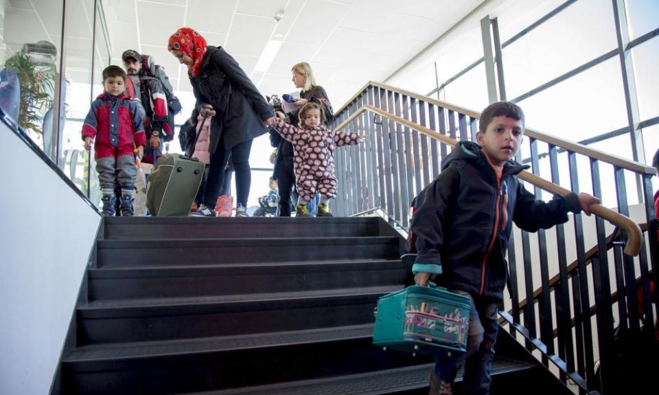 Passengers, among them migrants and refugees, exit the ferry terminal in Goteborg, Sweden.