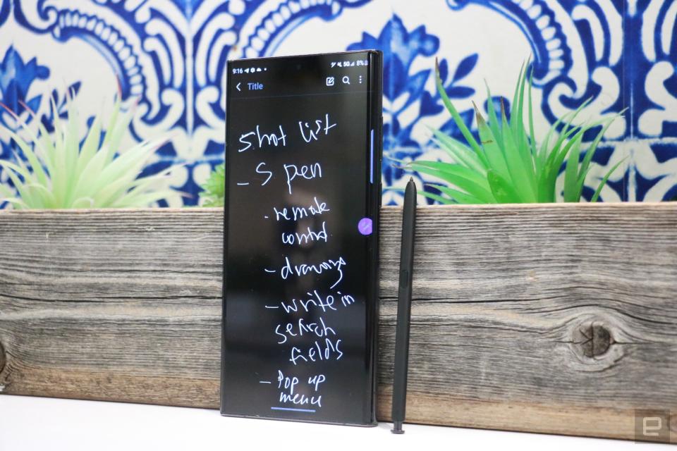 <p>The Samsung Galaxy S22 Ultra leaning against a planter, next to the S Pen. Its screen shows a handwritten list titled "Shot list."</p>
