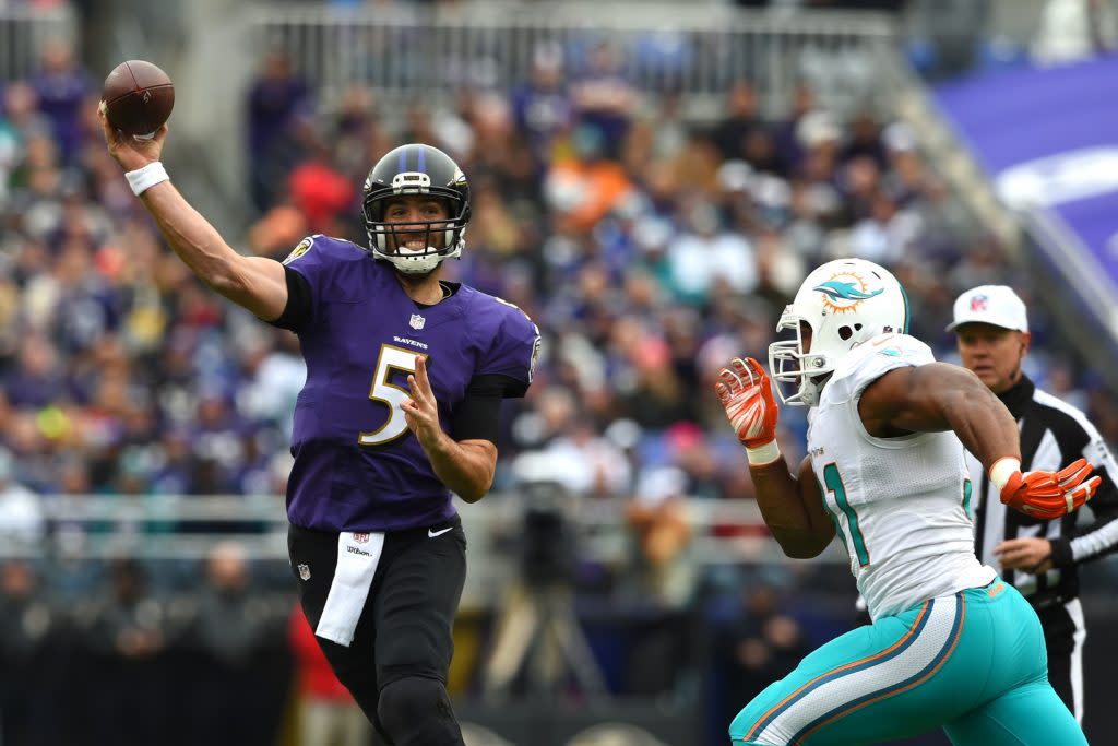 Dec 4, 2016; Baltimore, MD, USA; Baltimore Ravens quarterback Joe Flacco (5) throws as Miami Dolphins center Mike Pouncey (51) applies pressure during the first quarter at M&T Bank Stadium. Mandatory Credit: Tommy Gilligan-USA TODAY Sports