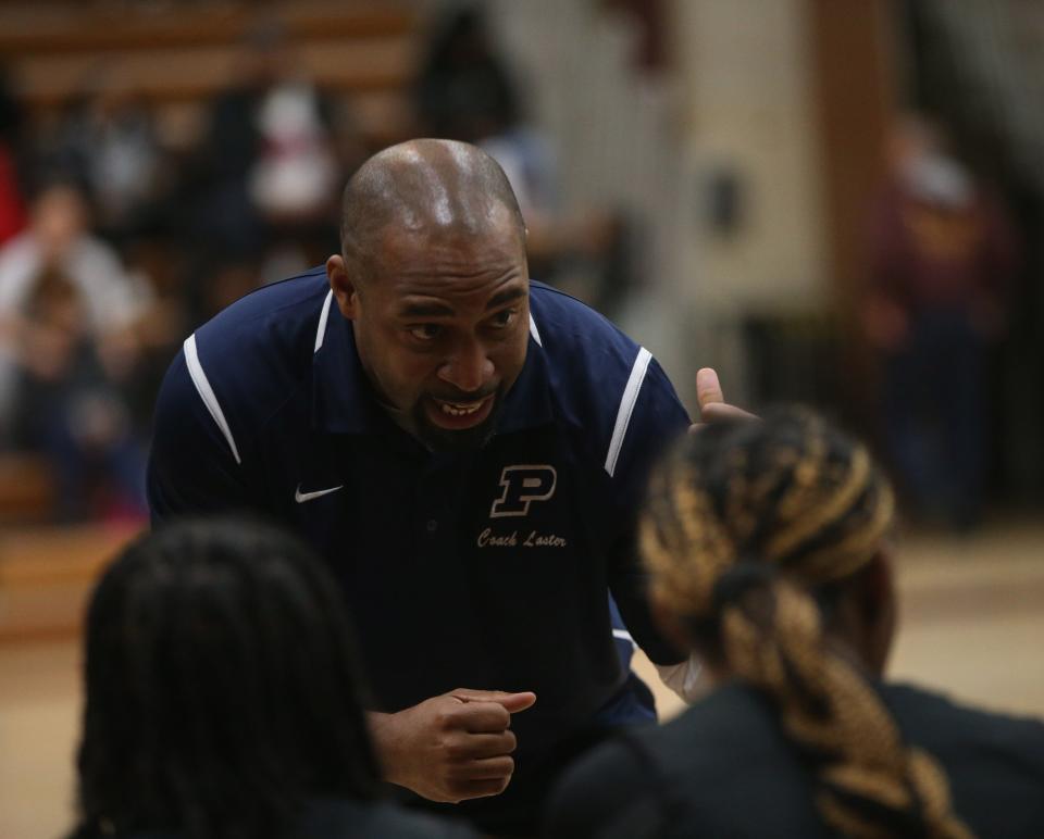 Poughkeepsie coach Joe Laster discusses strategy with his girls basketball team in a timeout during a Jan. 31, 2024 game.