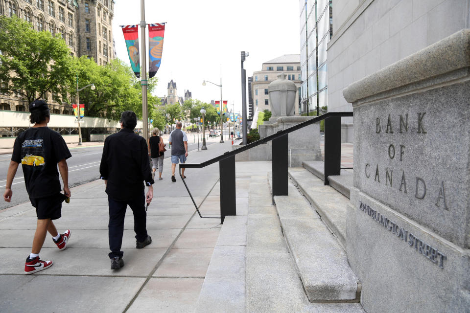 Pedestrians walk past the Bank of Canada in Ottawa, Ontario, Canada, on July 12, 2023. Canada's central bank on July 12, 2023, raised its key interest rate by 25 basis points to five percent, its highest level since 2001. While the Bank of Canada acknowledged that global inflation was easing, it explained its decision -- which was in line with analyst expectations -- by saying: 