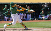 Oakland Athletics' Shea Langeliers hits a two-run home run against the Texas Rangers during the second inning in the second baseball game of a doubleheader Wednesday, May 8, 2024, in Oakland, Calif. (AP Photo/Godofredo A. Vásquez)