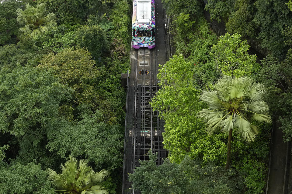A Peak Tram passes an uphill of the Victoria Peak in Hong Kong on June 17, 2021. Hong Kong’s Peak Tram is a fixture in the memories of many residents and tourists, ferrying passengers up Victoria Peak for a bird’s eye view of the city’s many skyscrapers. (AP Photo/Vincent Yu)