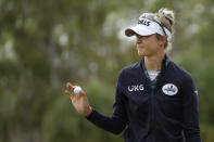 Nelly Korda of the U.S. holds up her ball after sinking a putt on the first green during the third round of the LPGA Tour Championship golf tournament, Saturday, Nov. 20, 2021, in Naples, Fla. (AP Photo/Rebecca Blackwell)
