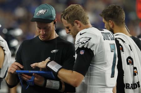 FILE PHOTO: Aug 16, 2018; Foxborough, MA, USA; Philadelphia Eagles quarterback Carson Wentz (11) talks with quarterback Nate Sudfeld (7) in the second half as they take on the New England Patriots at Gillette Stadium. Patriots defeated the Eagle 37-20. Mandatory Credit: David Butler II-USA TODAY Sports