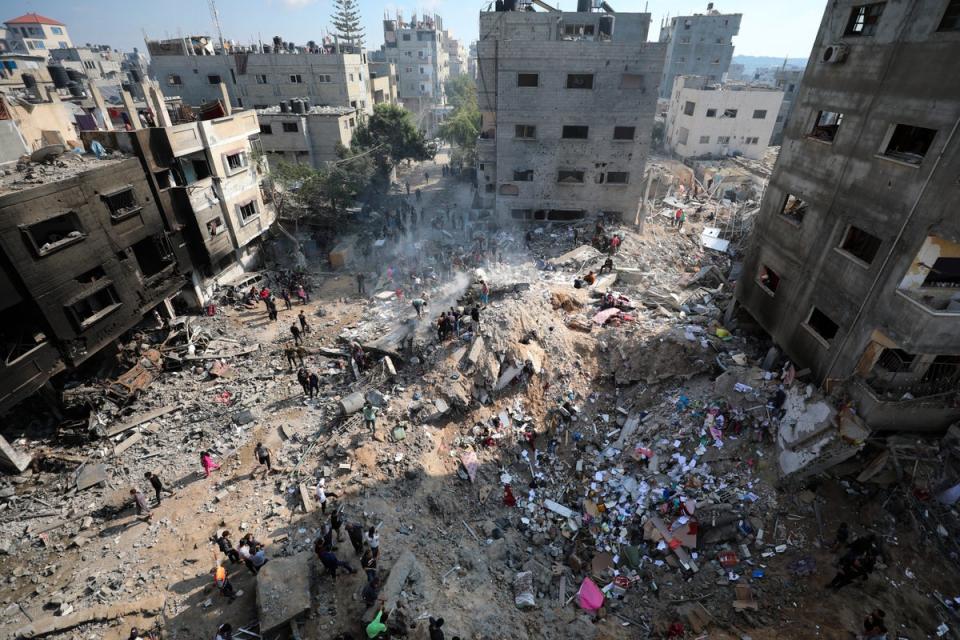 Palestinians inspect the destruction after an Israeli strike on the Gaza Strip in Nusseirat refugee camp on Friday (AP Photo/Marwan Saleh)