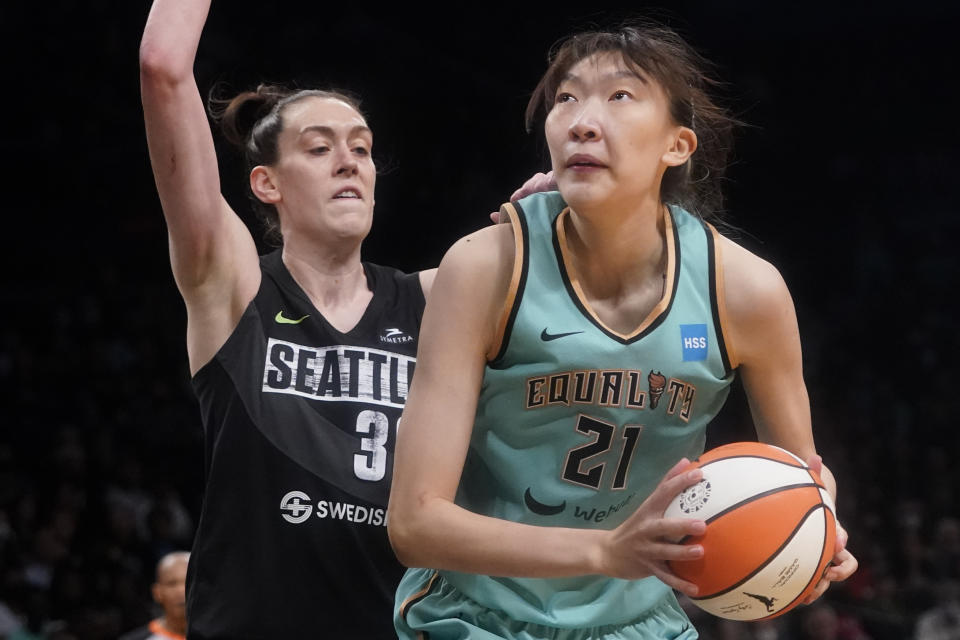 FILE - New York Liberty center Han Xu (21) drives against Seattle Storm forward Breanna Stewart, left, during the second half of a WNBA basketball game, Sunday, June 19, 2022, in New York. Standing 6-10, Han would like to emulate Yao Ming's impact — including his influence on the sport in China. She wants to be a female beacon of basketball in her native land. (AP Photo/Mary Altaffer, File)