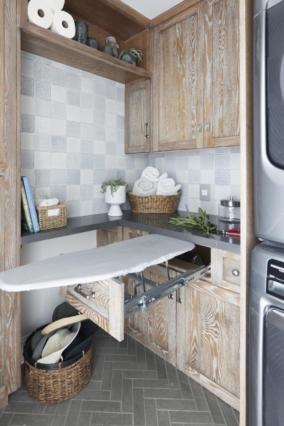 This image provided by Jeanne Chung/CozyStylishChic shows a laundry room. Laundry rooms are now often multi-use spaces. Have enough shelving, and keep it organized, not just for laundry products but all the stuff that goes with a multiuse room. (Dylan Riley Foto/CozyStylishChic via AP)