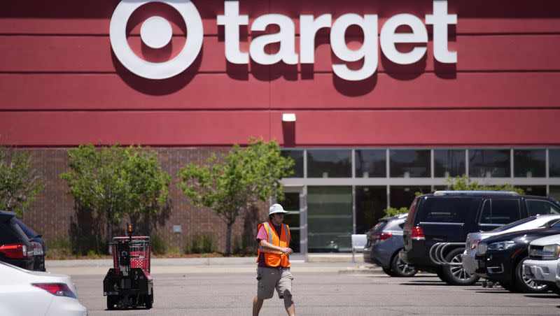 A worker collects shopping carts in the parking lot of a Target store on June 9, 2021, in Highlands Ranch, Colo. Target is removing certain items from its stores and making other changes to its LGBTQ merchandise nationwide ahead of Pride month, after an intense backlash from some customers including violent confrontations with its workers.