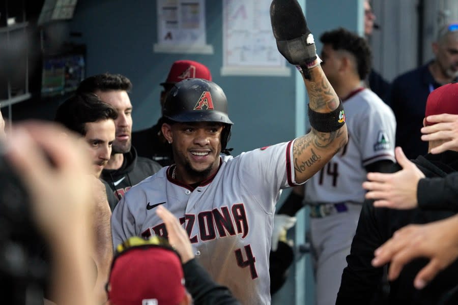 Arizona Diamondbacks’ Ketel Marte celebrates in the dugout after scoring on an RBI single by Corbin Carroll during the first inning in Game 1 of a baseball NL Division Series against the Los Angeles Dodgers, Saturday, Oct. 7, 2023, in Los Angeles. (AP Photo/Mark J. Terrill)