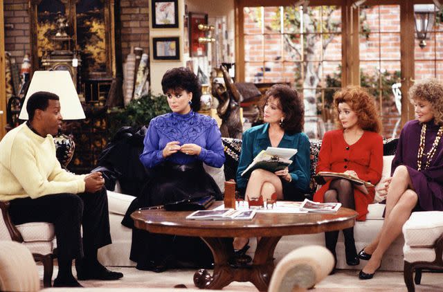 <p>CBS via Getty </p> From left: Meshach Taylor (as Anthony Taylor), Delta Burke (as Suzanne Sugarbaker), Dixie Carter (as Julia Sugarbaker), Annie Potts (as Mary Jo Shively) and Jean Smart (as Charlene Frazier) in 'Designing Women'