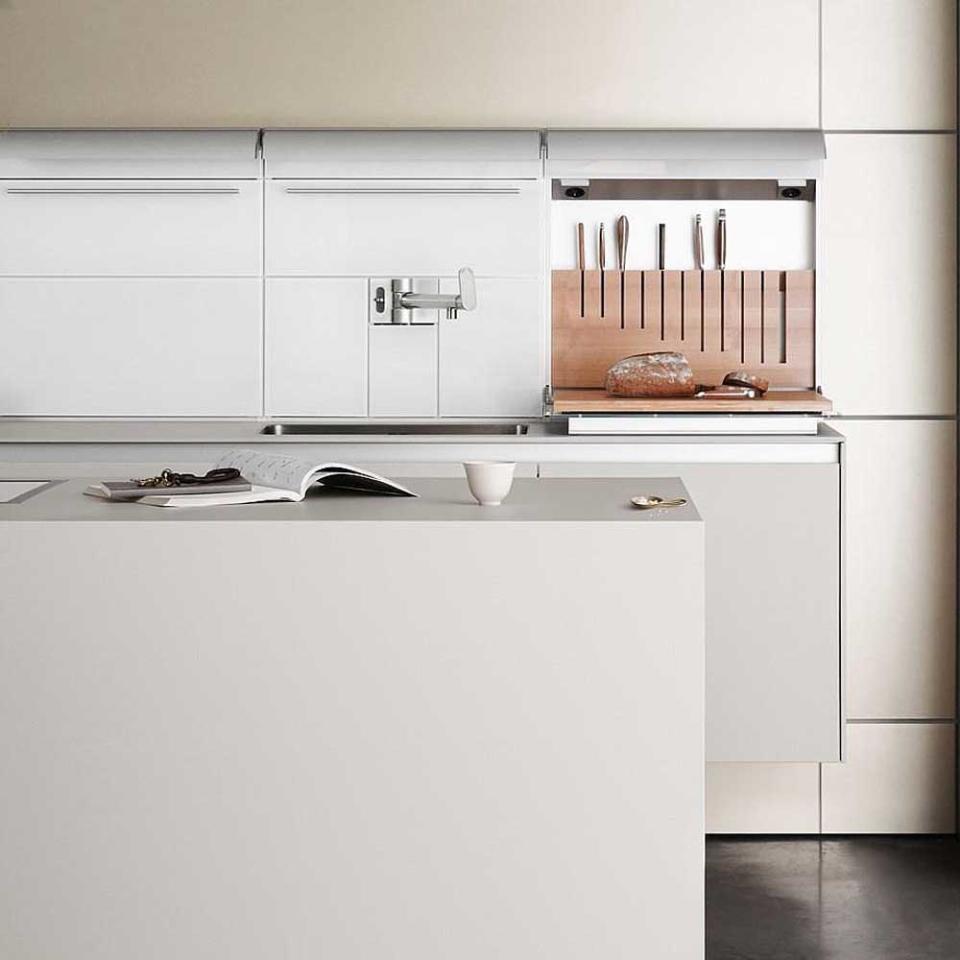 cream built-in kitchen with black floor tiles